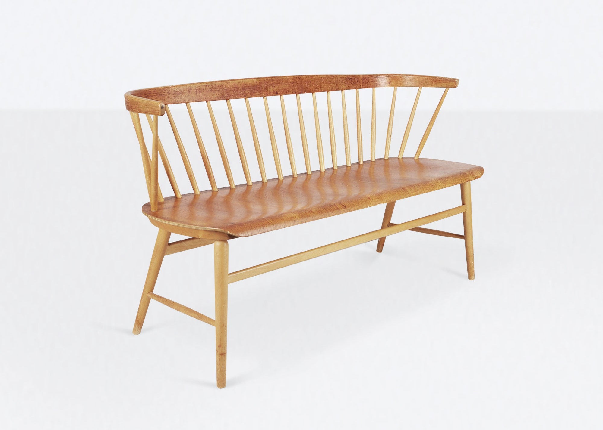 Wooden bench with spindle backrest on a white background