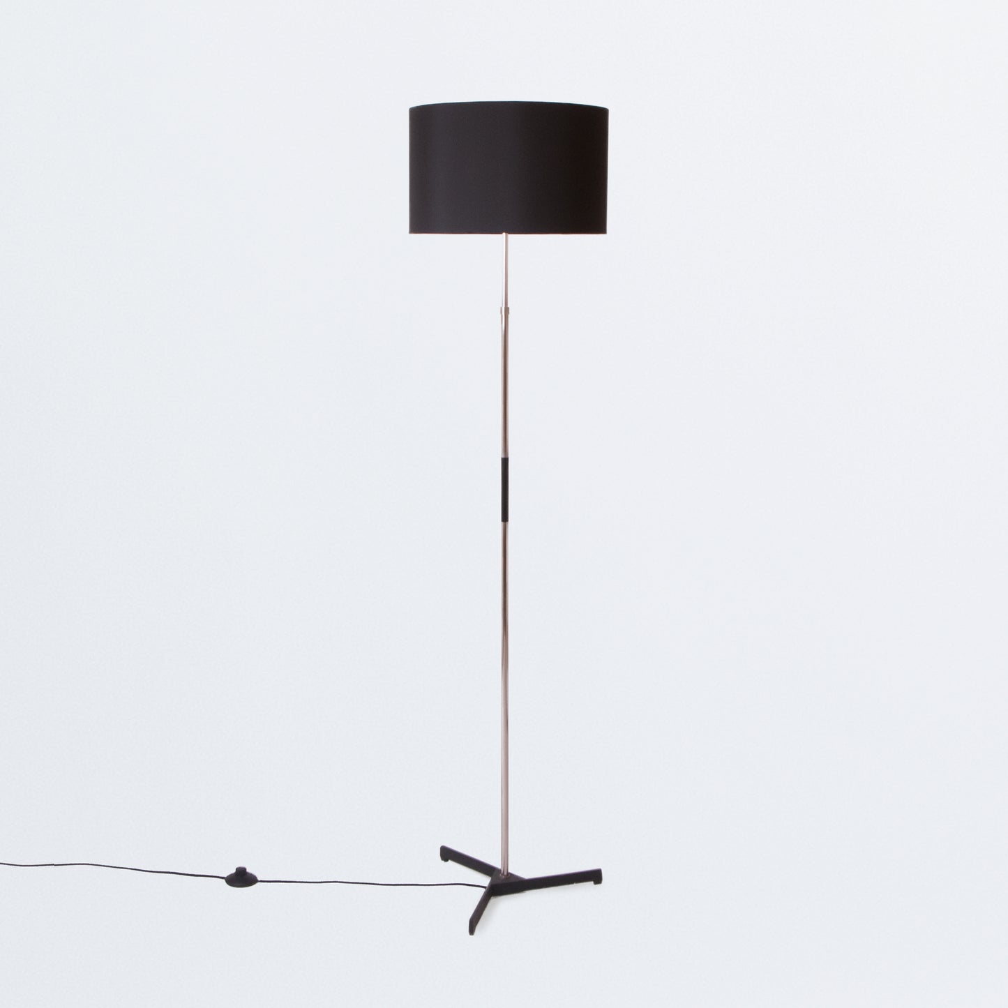 Floor lamp on black tripod base