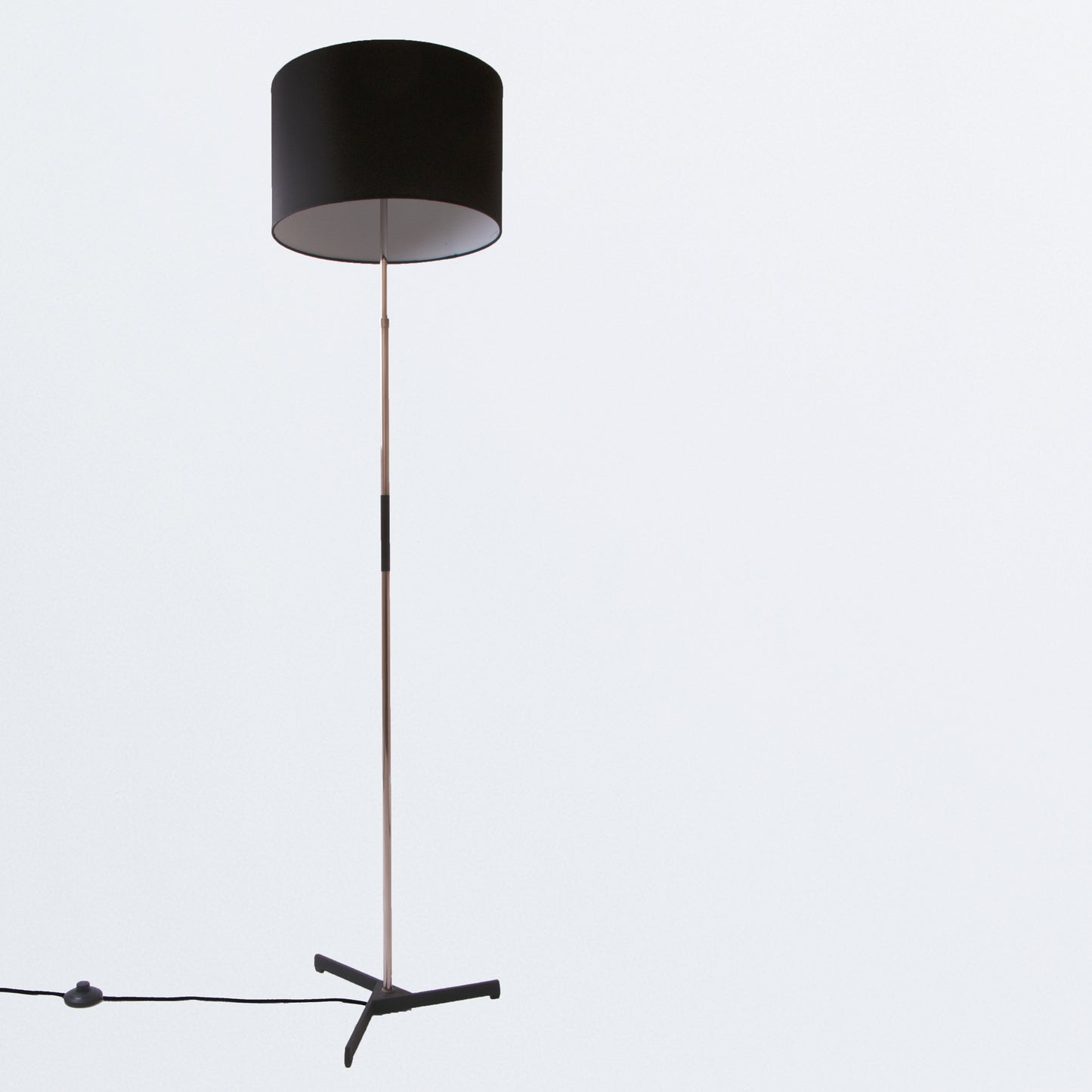 Floor lamp on black tripod base