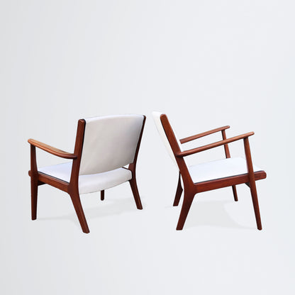 Pair of easy chairs with leather piping