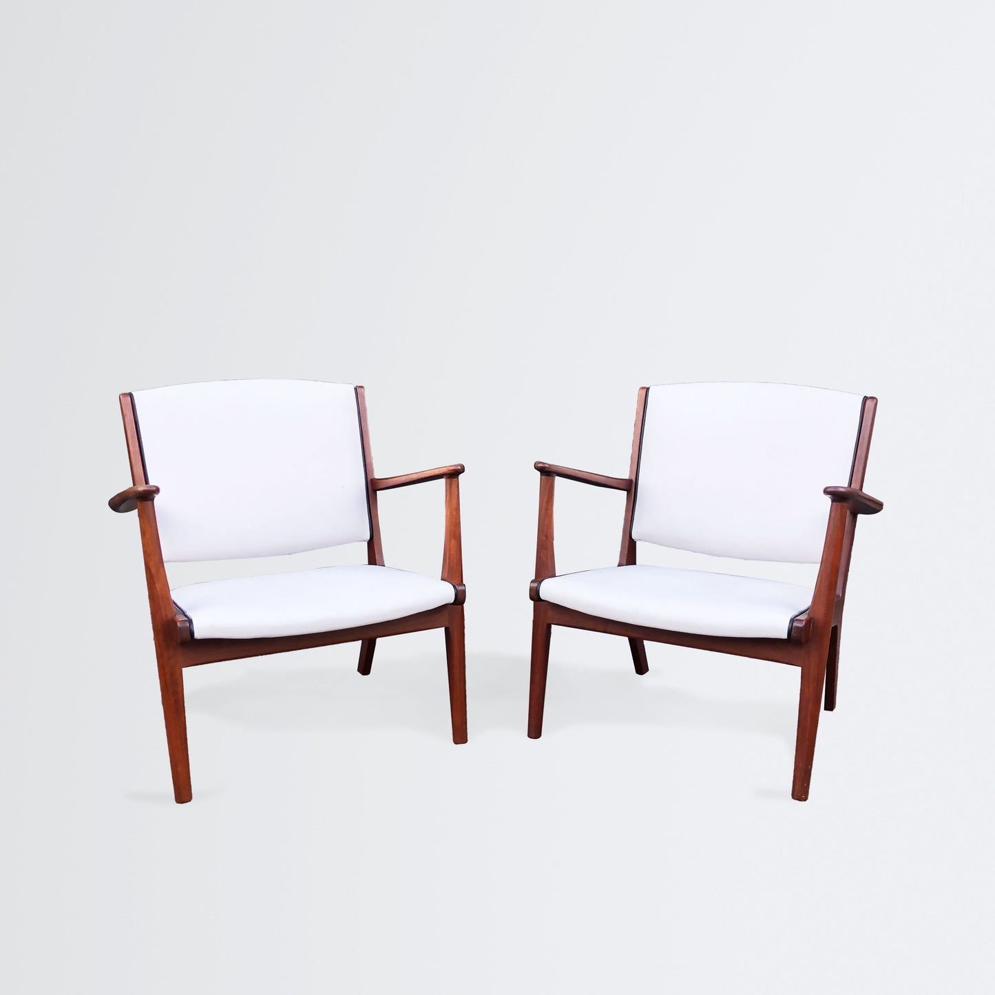 Pair of easy chairs with leather piping