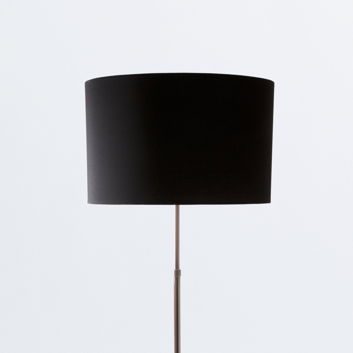 Floor lamp on black tripod base